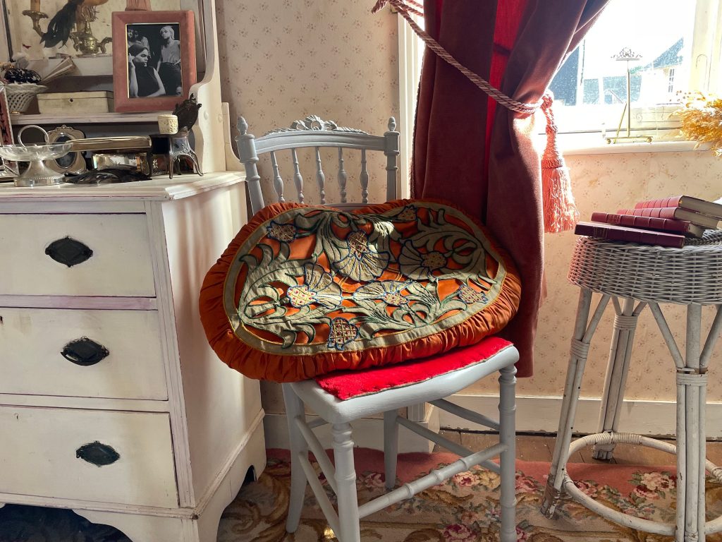Antique French Orange Satin Oval Pillow Cushion with Linen Flower Overlay Couch Bed Chair or Sofa circa 1910-20’s